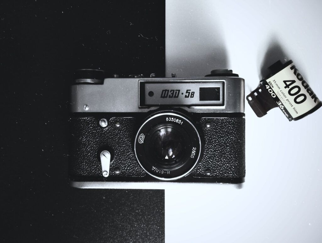black and gray film camera on white and black board